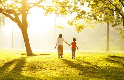 Mother and child walking in the woods.