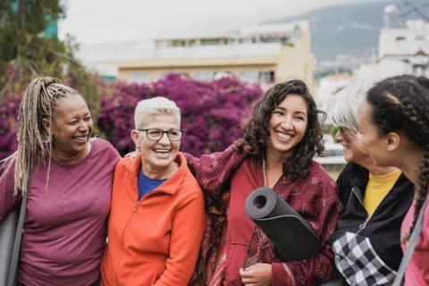 A happy multiracial group of women conversing.